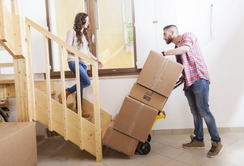 Warehouse worker using safe lifting practices near stored items
